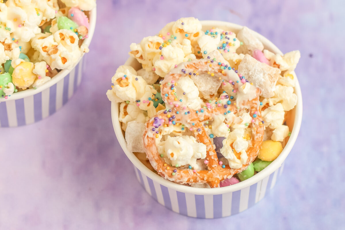 Try this Bunny Bait Recipe featuring popcorn, muddy buddies, pretzels, and candy coated in white chocolate covered in sprinkles this Easter!