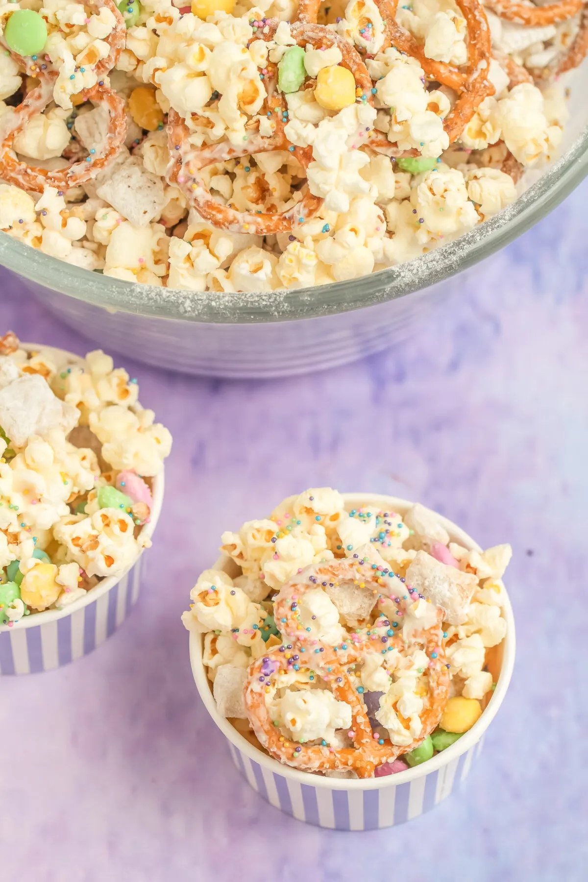 Try this Bunny Bait Recipe featuring popcorn, muddy buddies, pretzels, and candy coated in white chocolate covered in sprinkles this Easter!