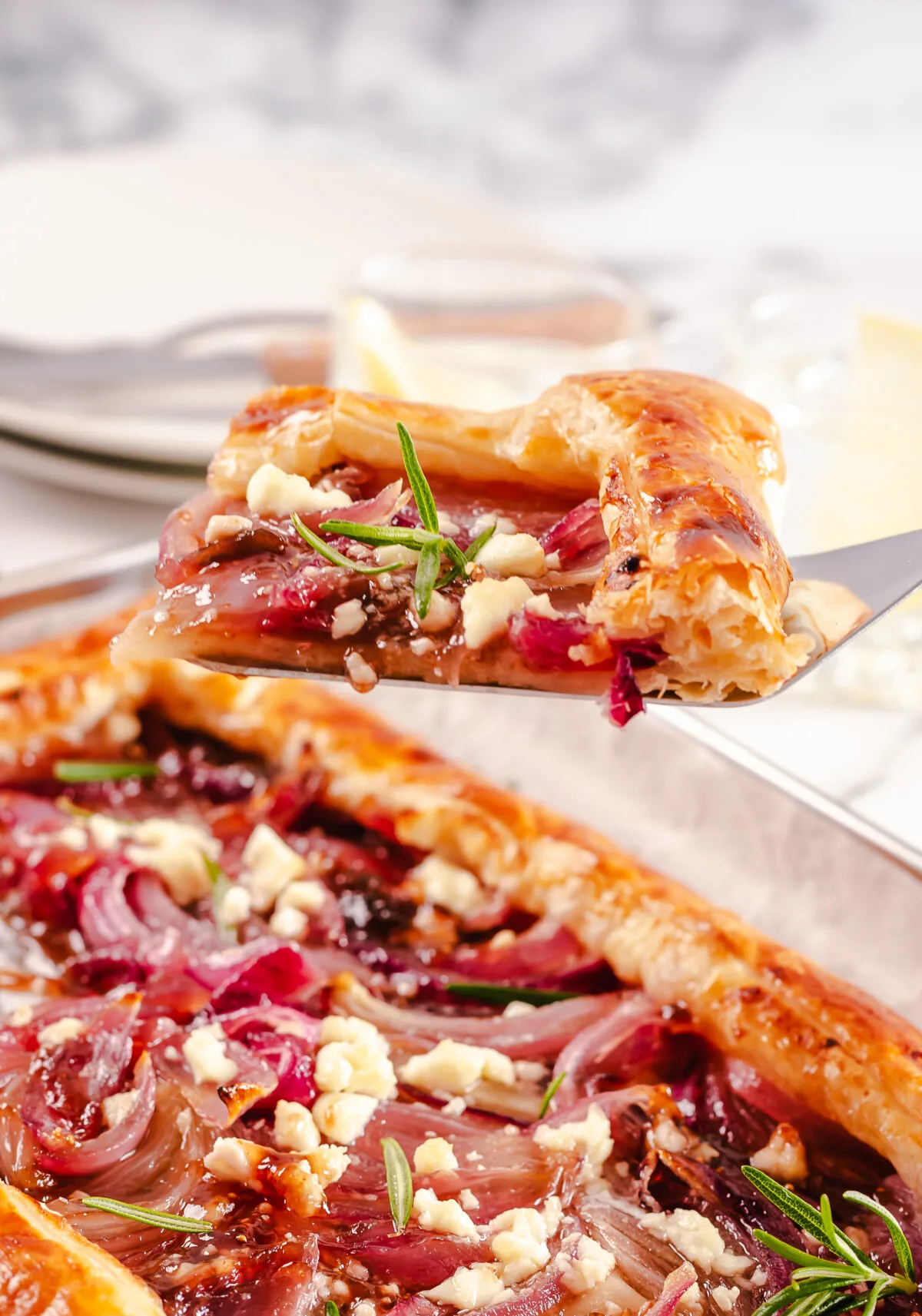 Up your dinner party game with this Caramelized Onion Tart recipe. With puff pastry, red onions, and feta cheese, it's an easy crowd pleaser.
