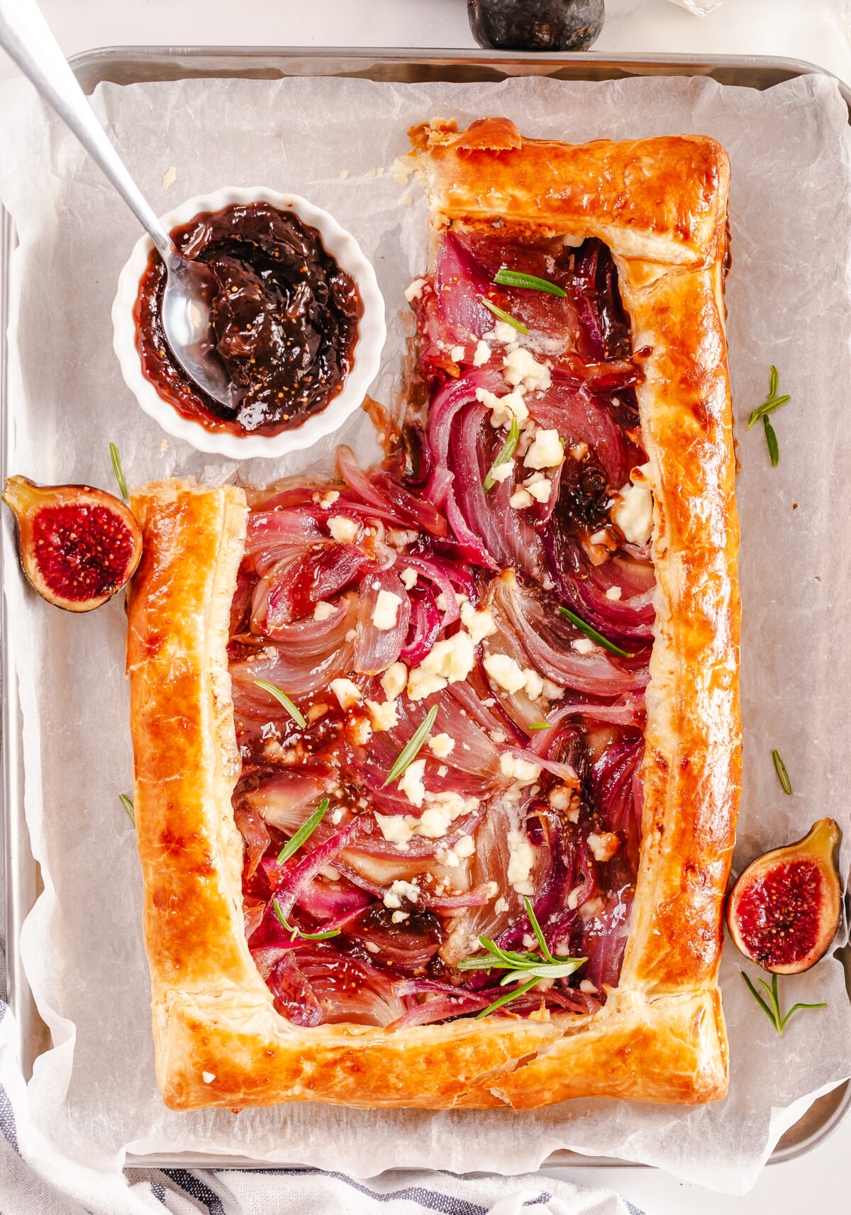 Up your dinner party game with this Caramelized Onion Tart recipe. With puff pastry, red onions, and feta cheese, it's an easy crowd pleaser.