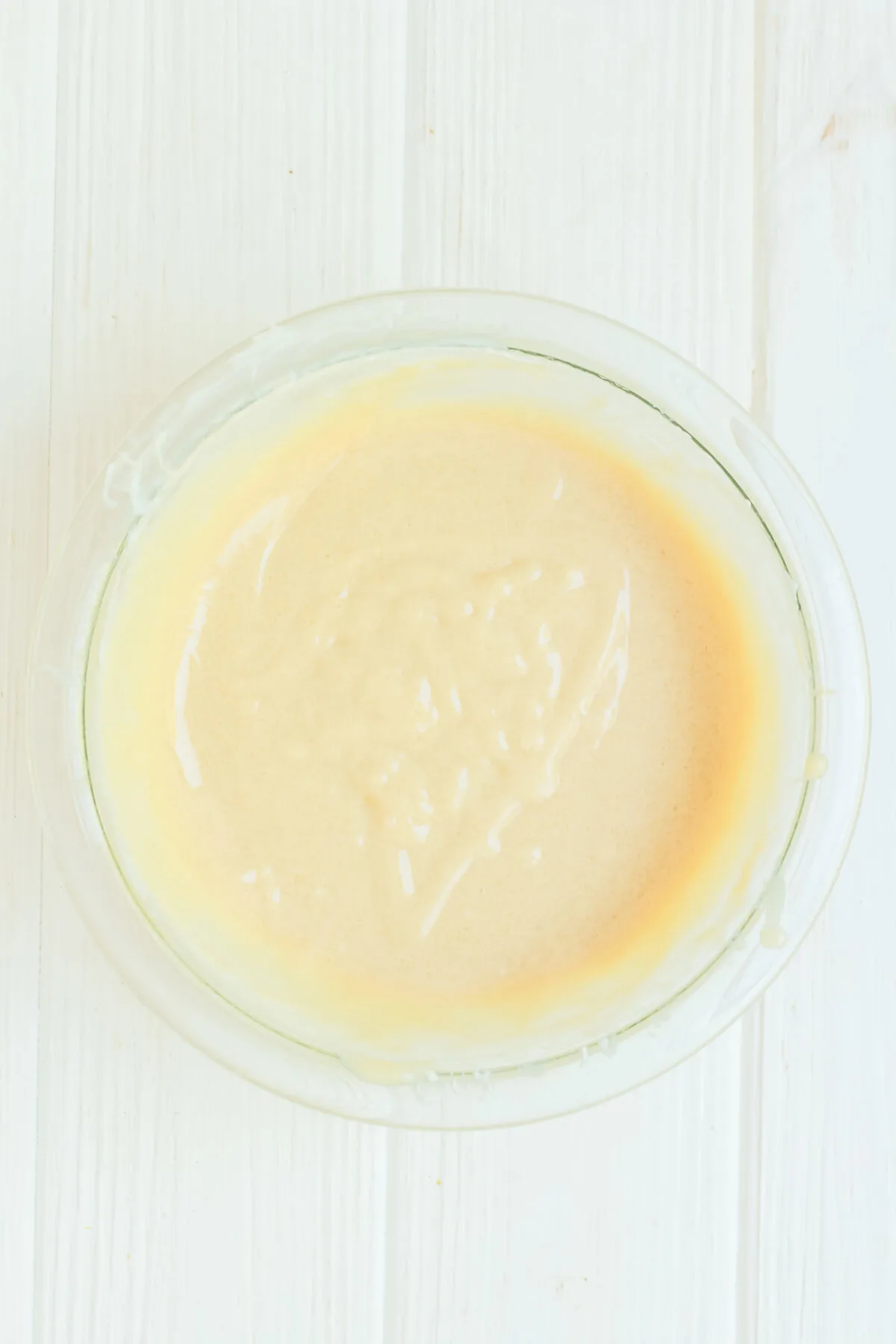 Cream cheese mixture combined in a glass bowl.