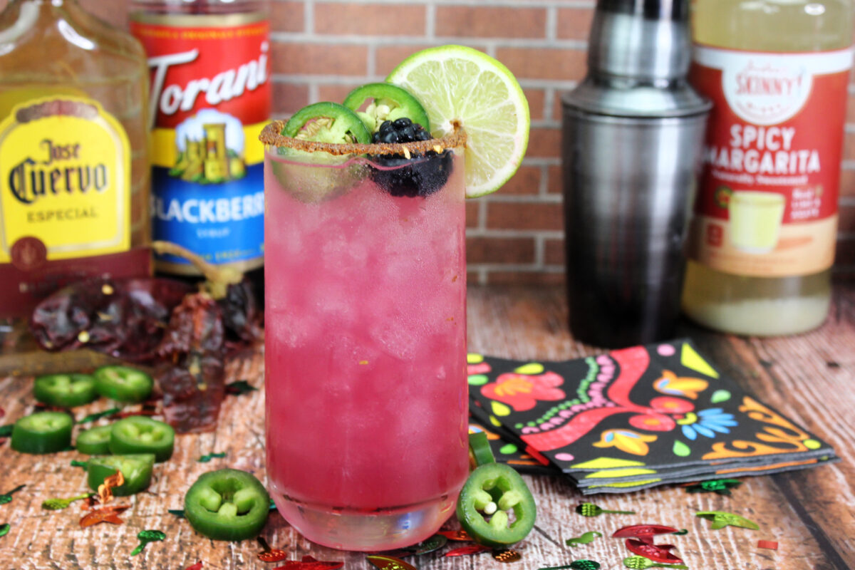 Spice up your summer with this delicious Spicy Blackberry Margarita recipe made with Tajin seasoning, Tequila, blackberry liqueuer, and more.