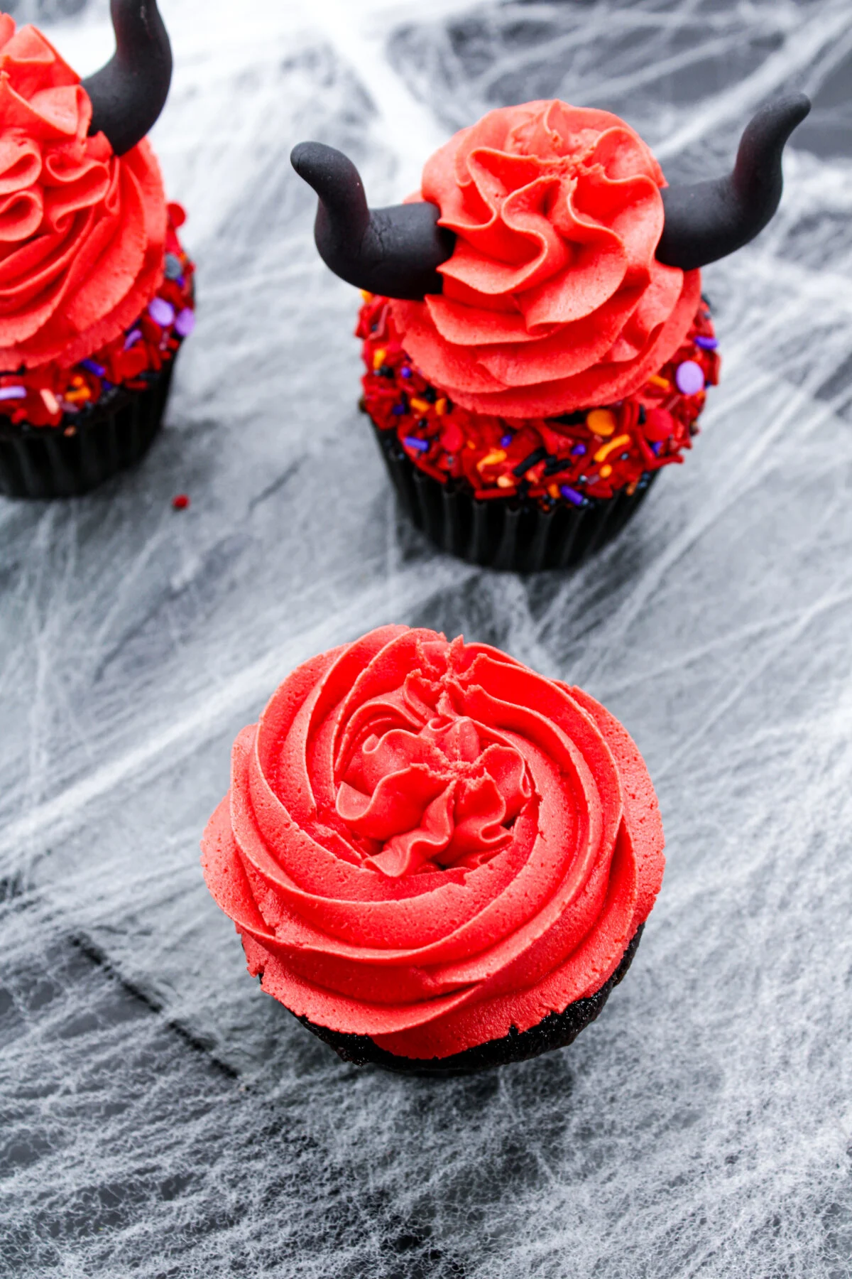 Cupcake frosted with red frosting.