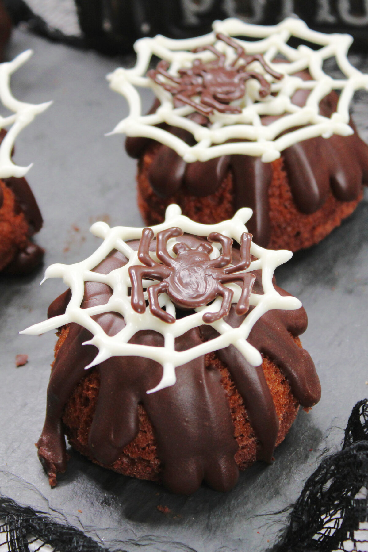 Get creative this Halloween and whip up these spooky, yet delicious mini spider bundt cakes decorated with chocolate spiders and webs.