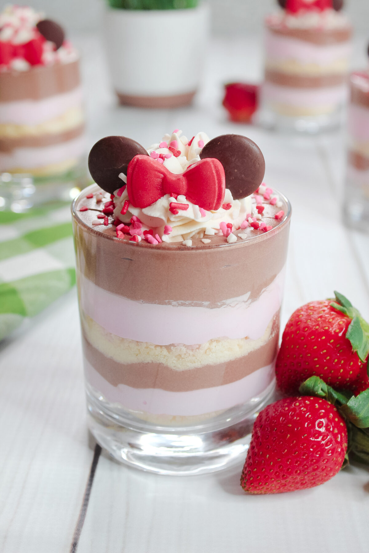 Indulge in whimsical Minnie Mouse Strawberry Parfaits with their layers of creamy strawberry and chocolate this Valentine's Day!